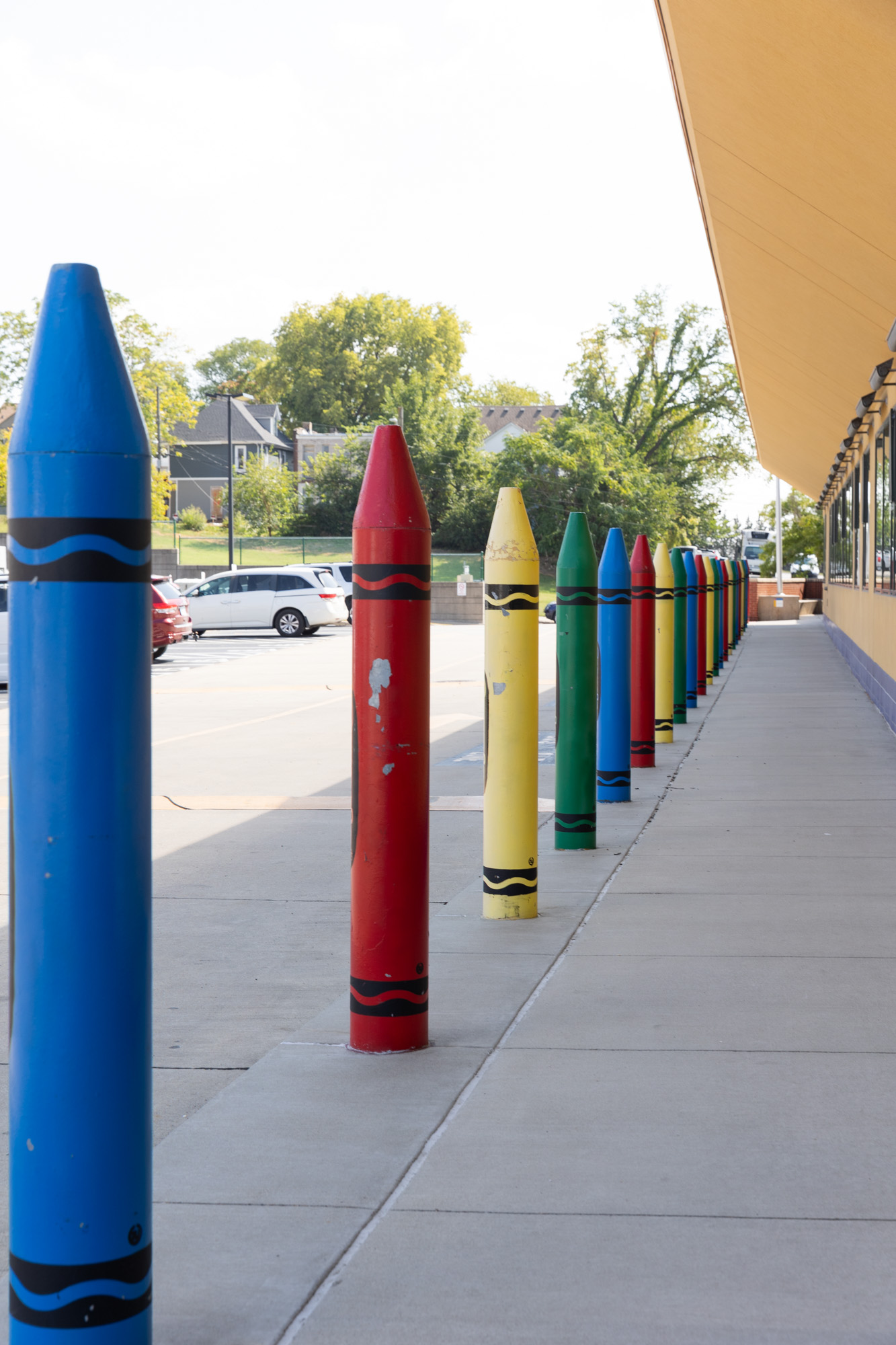Photo of crayons lining outside of parking lot at preschool