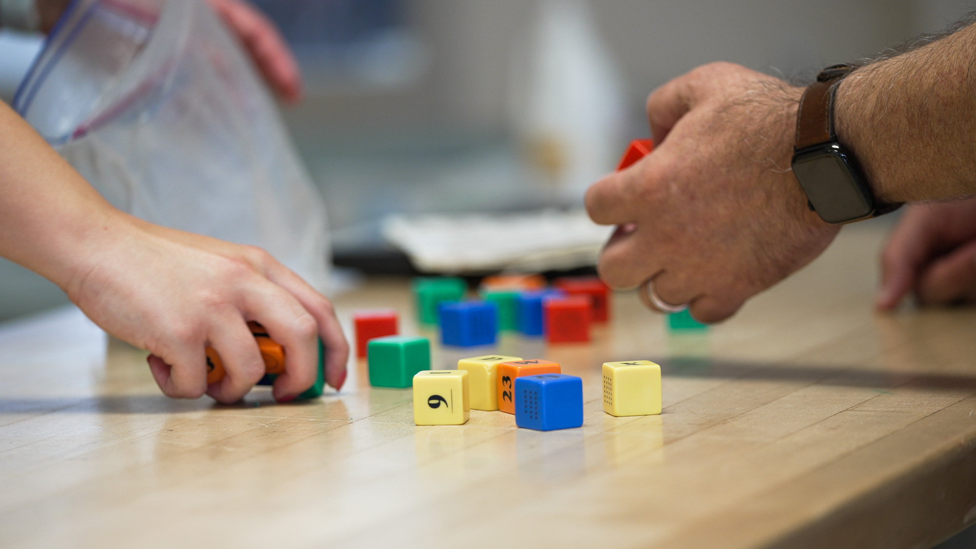patient picking up colorful blocks