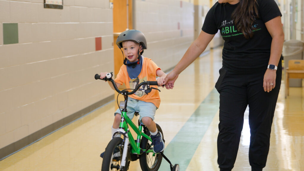 child riding bike in preschool