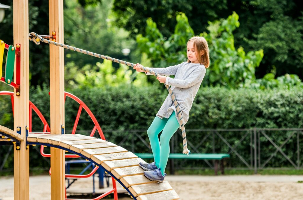 Child climbing with rope on playground